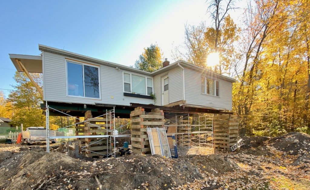 House on wood cribbing with scaffolding