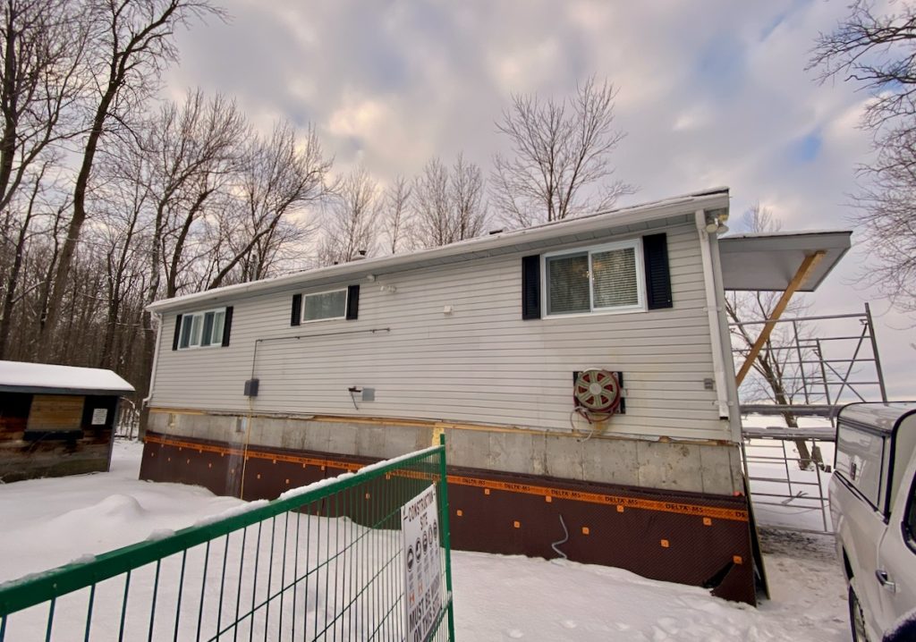 House resting on new concrete foundation