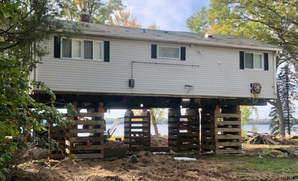house lifted for construction on wood cribbing